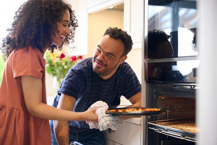 A carer helping a patient with cooking