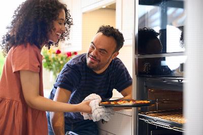 A carer helping a man with cooking