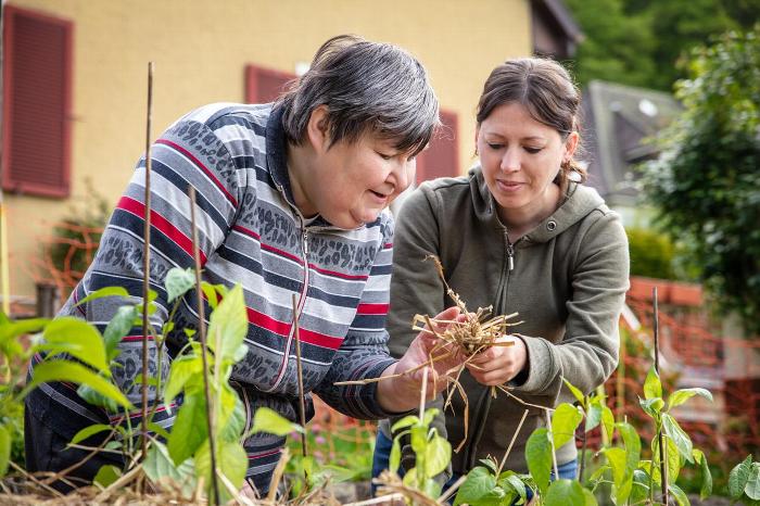 A carer helping a woman with gardening