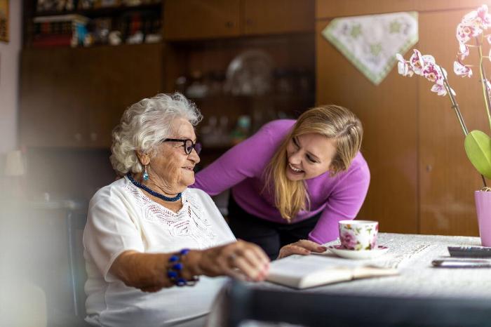 A carer talking to an elderly woman